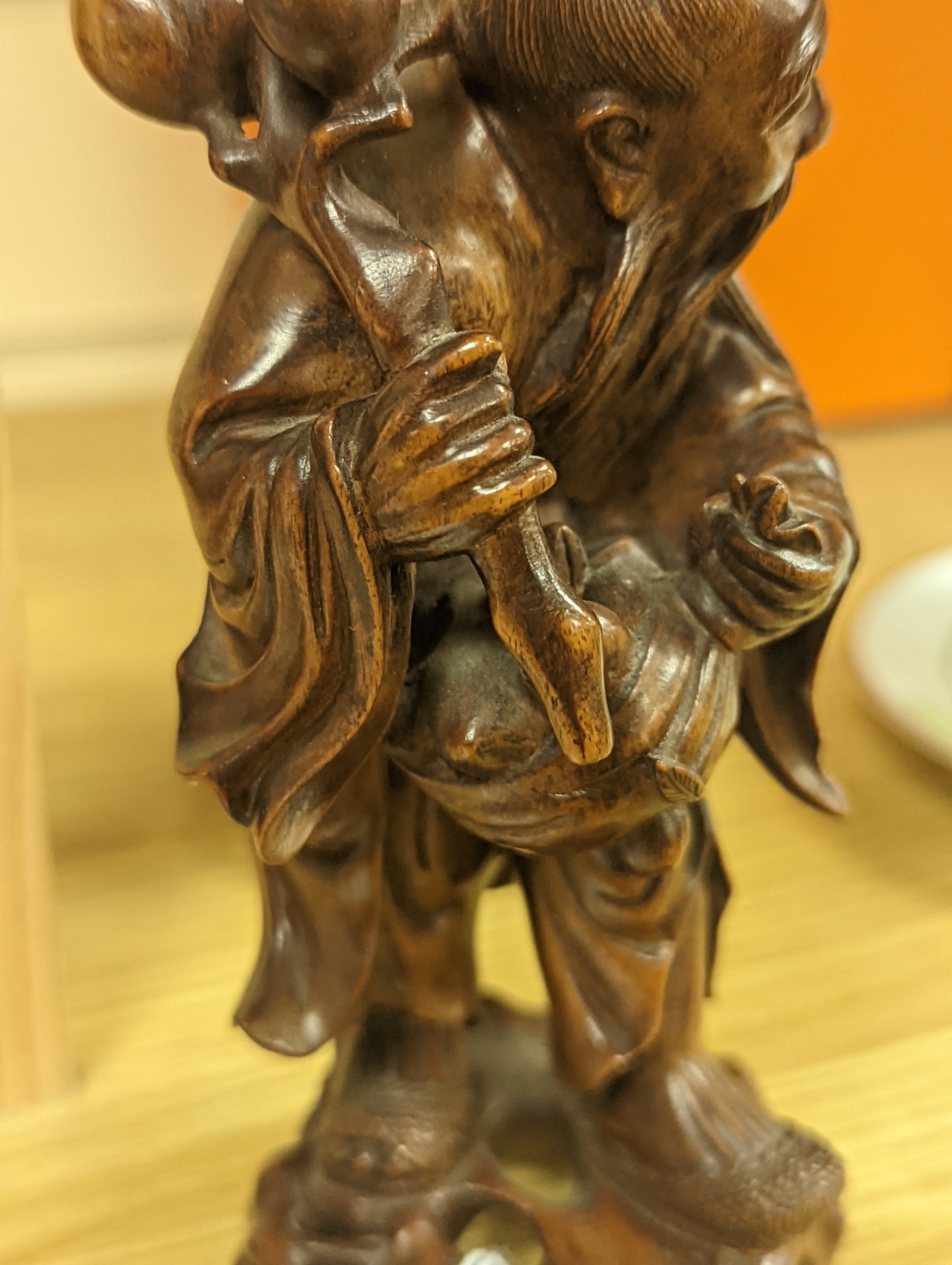 Two Chinese hardwood figures of a fisherman and a old man holding peaches 16cm